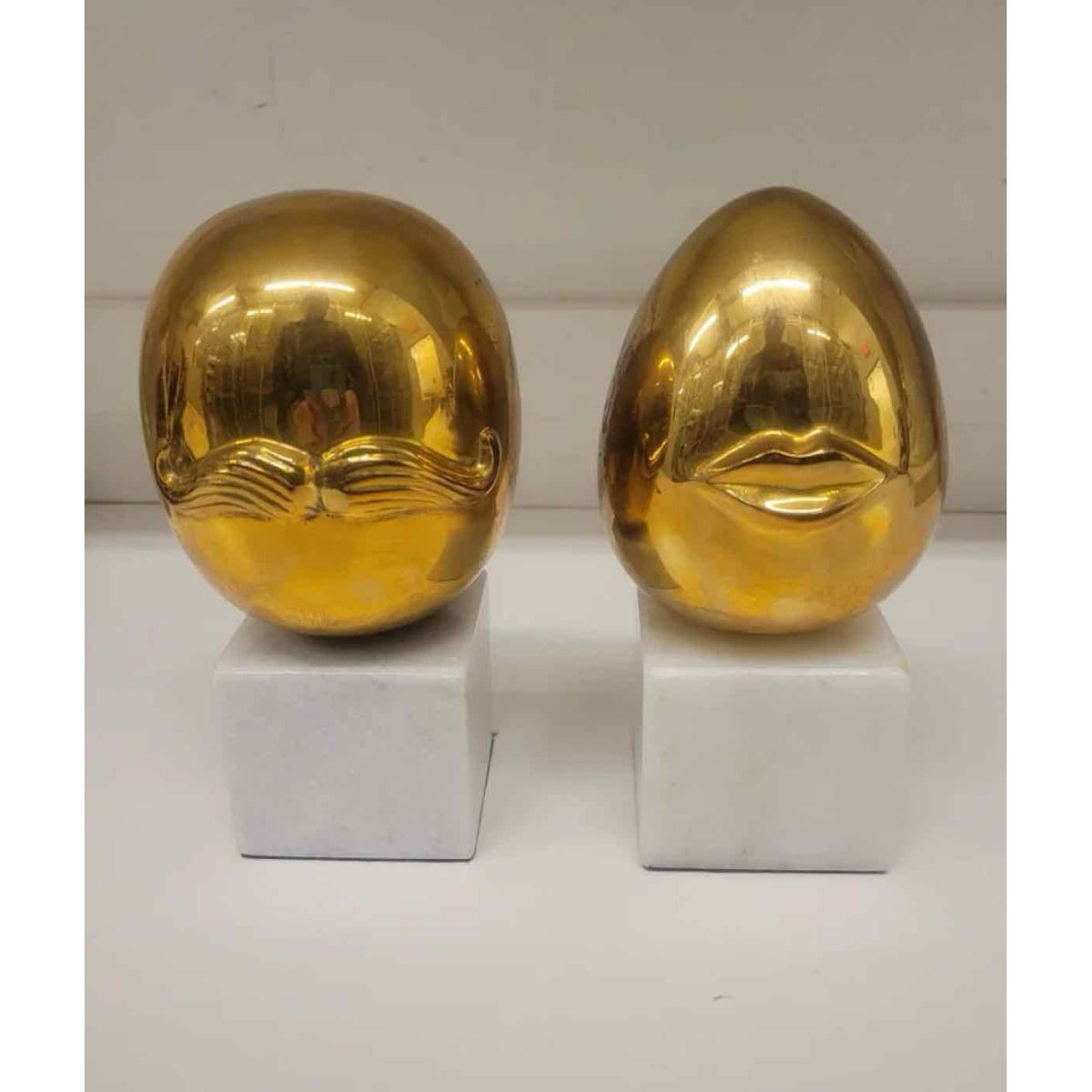 Pair of Mr. & Mrs. Brass Eggs on Marble Bases by Jonathon Adler