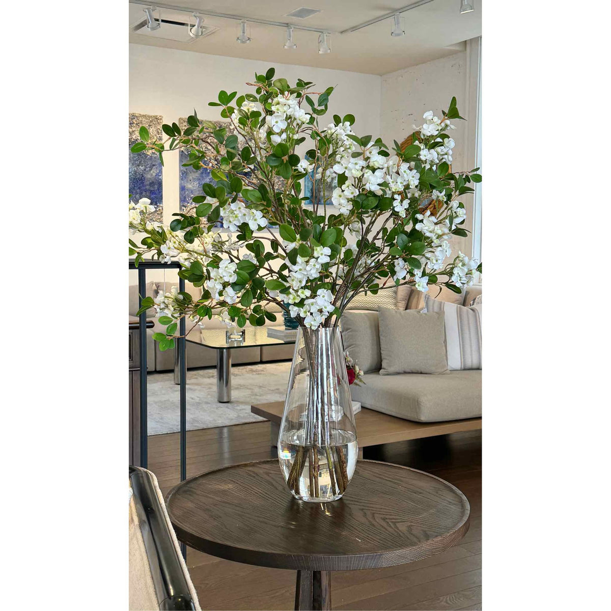 BLOSSLF.GLS - White blossom and leaf bouquet in teardrop vase