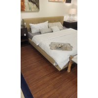 King-Sized Tan Upholstered Bed