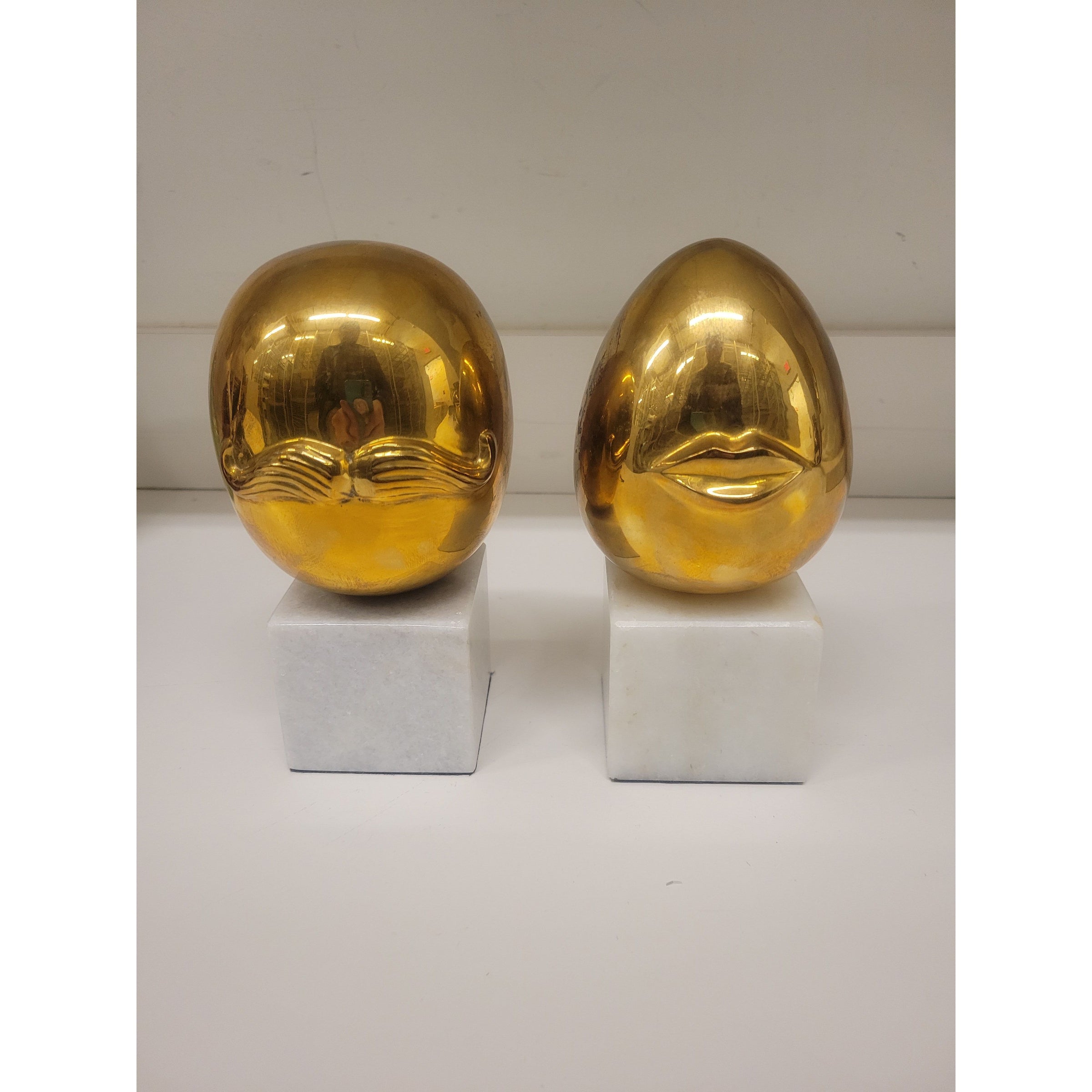 Pair of Mr. & Mrs. Brass Eggs on Marble Bases by Jonathon Adler